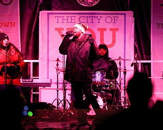 Josh Triplett performs before Youngstown's annual Holiday Parade on Friday night. EMILY MATTHEWS | THE VINDICATOR