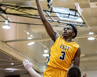 DIANNA OATRIDGE | THE VINDICATOR  Youngstown East's Deland Richardson (3) elevates to the basket over Boardman's Charlie Davis (24) during their game at Boardman High School Friday night.