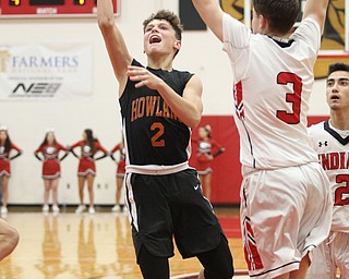 Howland's Gage Tomko (2) goes up for a shot while being defended by Girard's Matt Payich (3) during Friday nights matchup at Girard High School.  Dustin Livesay  |  The Vindicator  11/30/18  Girard