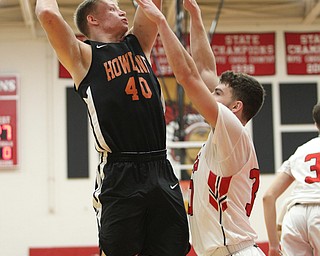 Austin O'Hara (33) defends a shot by Howland's Nathan Barrett (40) during Friday nights matchup at Girard High School.  Dustin Livesay  |  The Vindicator  11/30/18  Girard