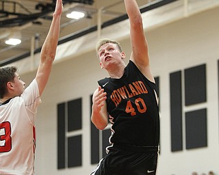 Howland's Nathan Barrett (40) puts up a hook shot while being defended by Girard's Austin O'Hara during Friday nights matchup at Girard High School.  Dustin Livesay  |  The Vindicator  11/30/18  Girard