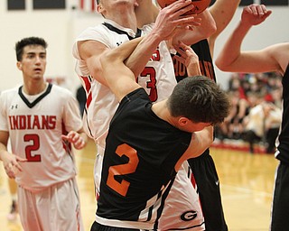 Austin O'Hara (33) of Girard gets fouled hard by Howland's Gage Tomko (2) during Friday nights matchup at Girard High School.  Dustin Livesay  |  The Vindicator  11/30/18  Girard