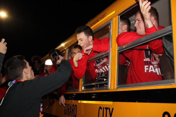 Dom Kendra poses for a picture as he hangs out of the window of the bus bound for Canton as the Girard football team plays for a state championship tomorrow night.  Dustin Livesay  |  The Vindicator  11/30/18  Girard