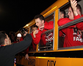 Dom Kendra poses for a picture as he hangs out of the window of the bus bound for Canton as the Girard football team plays for a state championship tomorrow night.  Dustin Livesay  |  The Vindicator  11/30/18  Girard