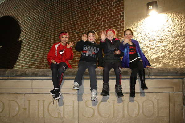L-R) Chloe Plant (9), Lauren Greene (8), Gianna Saxon (8), and Gianna Schubert (9) all of Girard wave to the football players as they pass by to board the buses on route to the state championship game in Canton on Saturday night. Dustin Livesay  |  The Vindicator  11/30/18  Girard
