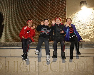 L-R) Chloe Plant (9), Lauren Greene (8), Gianna Saxon (8), and Gianna Schubert (9) all of Girard wave to the football players as they pass by to board the buses on route to the state championship game in Canton on Saturday night. Dustin Livesay  |  The Vindicator  11/30/18  Girard