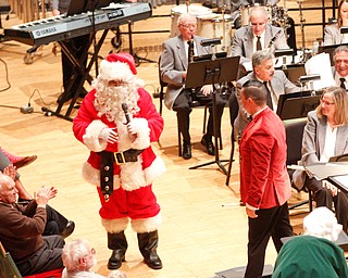 Santa greets the crowd during The Packard Band annual Christmas Spectacular at W.D. Packard Music Hall on Sunday afternoon. EMILY MATTHEWS | THE VINDICATOR