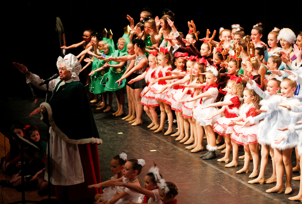 Dancers join Mrs. Claus to sing and dance to the song Baby Shark during The Packard Band annual Christmas Spectacular at W.D. Packard Music Hall on Sunday afternoon. EMILY MATTHEWS | THE VINDICATOR