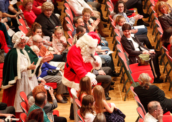 Santa greets the crowd with Mrs. Claus during The Packard Band annual Christmas Spectacular at W.D. Packard Music Hall on Sunday afternoon. EMILY MATTHEWS | THE VINDICATOR