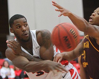 William D. Lewis the Vindicator  YSU's Naz Bohannon(33) passes around CMU's Romelo Burrell(24) during 12-4-18 action at YSU.