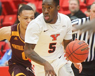 William D. Lewis the Vindicator  YSU's Kendale HAmpton(5) drives around CMU's Larry Austin Jr.(0) during 12-4-18 action at YSU.