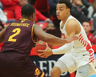 William D. Lewis the Vindicator  YSU's Darius Quisenberry(3) passes around CMU's Shawn Roundtree(2) during 12-4-18 action at YSU.