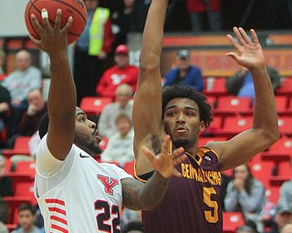 William D. Lewis the Vindicator  YSU's Devin Morgan(22) shoots around CMU's Rob Montgomery(5) during 12-4-18 action at YSU.