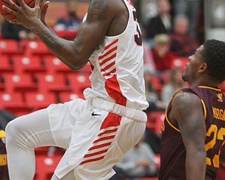 William D. Lewis the Vindicator  YSU's Naz Bohannon(33) drives around CMU's Matt Beachler(22) during 12-4-18 action at YSU.