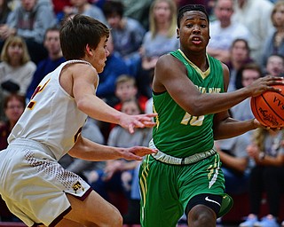 CANFIELD, OHIO - DECEMBER 4, 2018: Ursuline's Travis Easterly jr. drives on South Range's Nick Matos during the first half of their game, Tuesday night at South Range High School. DAVID DERMER | THE VINDICATOR