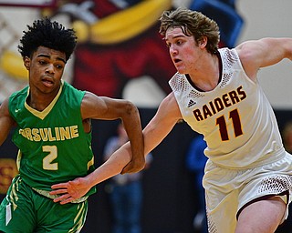 CANFIELD, OHIO - DECEMBER 4, 2018: Ursuline's Daysean Harris drives on South Range's Dante DiGaetano during the first half of their game, Tuesday night at South Range High School. DAVID DERMER | THE VINDICATOR