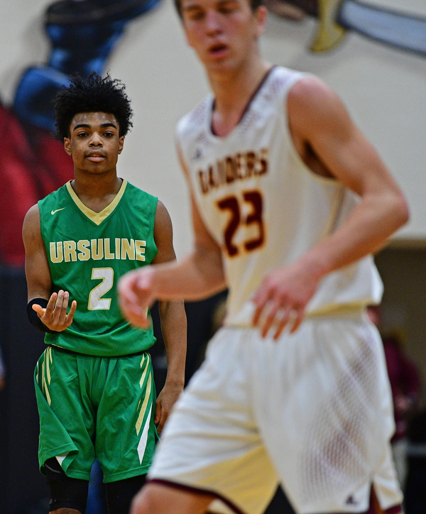 CANFIELD, OHIO - DECEMBER 4, 2018: Ursuline's Daysean Harris embellishes after hitting a three point shot in front of South Range's Jaxon Anderson during the first half of their game, Tuesday night at South Range High School. DAVID DERMER | THE VINDICATOR