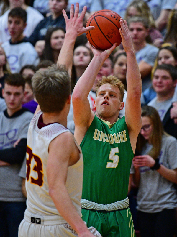 CANFIELD, OHIO - DECEMBER 4, 2018: Ursuline's Dylan Karlovic shoots a three point shot over South Range's Ben Irons during the first half of their game, Tuesday night at South Range High School. DAVID DERMER | THE VINDICATOR