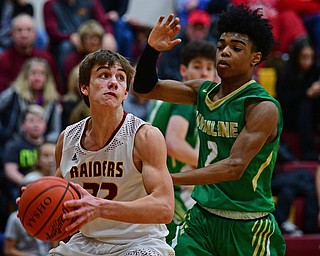 CANFIELD, OHIO - DECEMBER 4, 2018: South Range's Nick Matos drives on Ursuline's Daysean Harris during the first half of their game, Tuesday night at South Range High School. DAVID DERMER | THE VINDICATOR