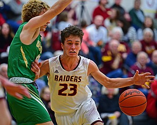 CANFIELD, OHIO - DECEMBER 4, 2018: South Range's Jaxon Anderson loses control of the ball while driving on Ursuline's Vincent Armini during the first half of their game, Tuesday night at South Range High School. DAVID DERMER | THE VINDICATOR