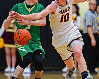 CANFIELD, OHIO - DECEMBER 4, 2018: South Range's Chris Brooks knocks the ball away from Ursuline's Patrick McLaughlin during the first half of their game, Tuesday night at South Range High School. DAVID DERMER | THE VINDICATOR