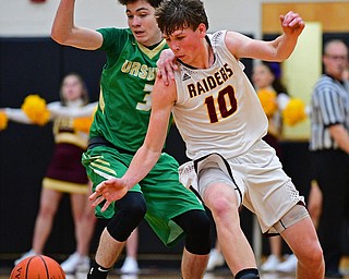 CANFIELD, OHIO - DECEMBER 4, 2018: South Range's Chris Brooks knocks the ball away from Ursuline's Patrick McLaughlin during the first half of their game, Tuesday night at South Range High School. DAVID DERMER | THE VINDICATOR