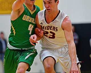 CANFIELD, OHIO - DECEMBER 4, 2018: South Range's Jaxon Anderson drives on Ursuline's Vincent Armini during the first half of their game, Tuesday night at South Range High School. DAVID DERMER | THE VINDICATOR