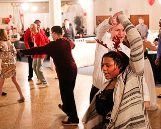 Harmonie Walker, 15, a student at Warren G. Harding High School, dances with Philip Davis, of Youngstown, at the 18th annual Winterfest dance at The Mahoning Country Club on Wednesday night. EMILY MATTHEWS | THE VINDICATOR