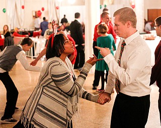 Harmonie Walker, 15, a student at Warren G. Harding High School, and Philip Davis, of Youngstown, dance to All I Want for Christmas is You at the 18th annual Winterfest dance at The Mahoning Country Club on Wednesday night. EMILY MATTHEWS | THE VINDICATOR