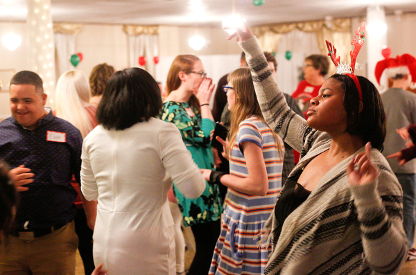 Harmonie Walker, right, 15, a student at Warren G. Harding High School, dances with other students at the 18th annual Winterfest dance at The Mahoning Country Club on Wednesday night. EMILY MATTHEWS | THE VINDICATOR