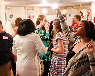 Harmonie Walker, right, 15, a student at Warren G. Harding High School, dances with other students at the 18th annual Winterfest dance at The Mahoning Country Club on Wednesday night. EMILY MATTHEWS | THE VINDICATOR