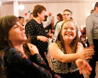 Christin Murcko, right, 16, a student at Poland High School, and Katelyn Hall, 16, a student at Fitch High School, dance the Macarena at the 18th annual Winterfest dance at The Mahoning Country Club on Wednesday night. EMILY MATTHEWS | THE VINDICATOR