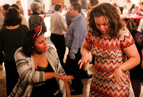 Harmonie Walker, left, 15, a student at Warren G. Harding High School, and Starr Spencer, 16, a student at Potential Development, dance at the 18th annual Winterfest dance at The Mahoning Country Club on Wednesday night. EMILY MATTHEWS | THE VINDICATOR