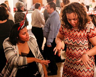 Harmonie Walker, left, 15, a student at Warren G. Harding High School, and Starr Spencer, 16, a student at Potential Development, dance at the 18th annual Winterfest dance at The Mahoning Country Club on Wednesday night. EMILY MATTHEWS | THE VINDICATOR