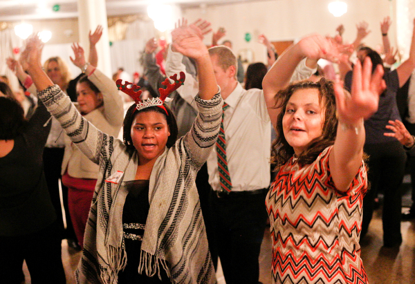 Harmonie Walker, left, 15, a student at Warren G. Harding High School, and Starr Spencer, 16, a student at Potential Development, dance at the 18th annual Winterfest dance at The Mahoning Country Club on Wednesday night. EMILY MATTHEWS | THE VINDICATOR