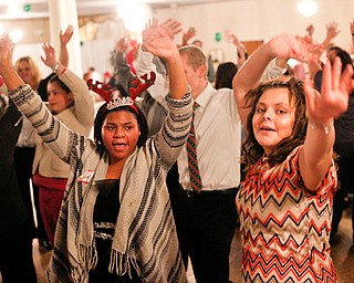 Harmonie Walker, left, 15, a student at Warren G. Harding High School, and Starr Spencer, 16, a student at Potential Development, dance at the 18th annual Winterfest dance at The Mahoning Country Club on Wednesday night. EMILY MATTHEWS | THE VINDICATOR