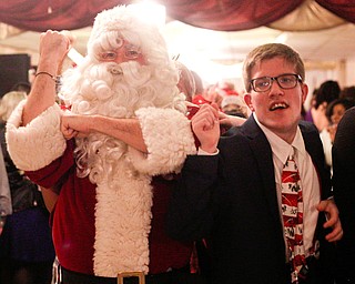 Santa leads a dance train with Adrian Sadlak, 21, a student  at Choffin Career and Technical Center, at the 18th annual Winterfest dance at The Mahoning Country Club on Wednesday night. EMILY MATTHEWS | THE VINDICATOR