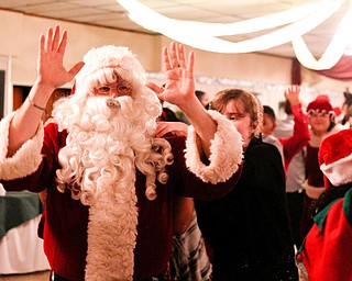 Santa leads a dance train at the 18th annual Winterfest dance at The Mahoning Country Club on Wednesday night. EMILY MATTHEWS | THE VINDICATOR