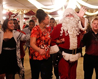 Santa dances with students at the 18th annual Winterfest dance at The Mahoning Country Club on Wednesday night. EMILY MATTHEWS | THE VINDICATOR