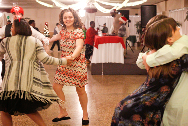 Starr Spencer, center, 16, a student at Potential Development, dances with other students while Katelyn Hall, 16, and Chad Berry, 15, both students at Fitch, hug on the dance floor at the 18th annual Winterfest dance at The Mahoning Country Club on Wednesday night. EMILY MATTHEWS | THE VINDICATOR