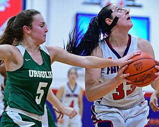 AUSTINTOWN, OHIO - DECEMBER 5, 2018: Fitch's Sabrina Hunter goes to the basket while being pressured by Ursuline's Cara McNally during the first half of their game, Wednesday night at Austintown Fitch High School. DAVID DERMER | THE VINDICATOR