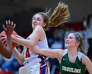 AUSTINTOWN, OHIO - DECEMBER 5, 2018: Fitch's Emma Bartlett pulls a rebound away from Ursuline's Jamie Nelson during the second half of their game, Wednesday night at Austintown Fitch High School. DAVID DERMER | THE VINDICATOR