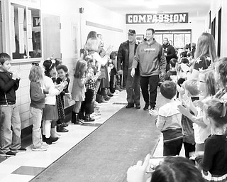 Neighbors | Jessica Harker.As veterans left Stadium Drive Elementary School, students and staffed lined the hallways to clap them out after the school's annual Veterans Day Breakfast on Nov. 9.