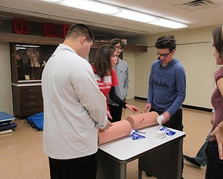 Neighbors | Jessica Harker.Students practiced packing wounds Nov. 14 with the help of Mercy Health representative Amanda Lencyk at Boardman High School.