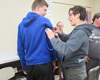 Neighbors | Jessica Harker.Student Nicholas Niarhr practiced placing a tourniquet on classmate Connor Dettmer Nov. 14 for the Stop the Bleed program at Boardman High School.