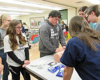 Neighbors | Jessica Harker.Haley Bajdas, a Mercy Health representative, taught students how to properly pack wounds to stop serious bleeding Nov. 14 at Boardman High School's Stop the Bleed program.