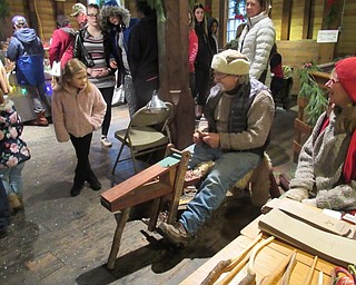 Neighbors | Jessica Harker.Vendors demonstrated their crafts, including wooden spoon carving, for community members gathered at the Olde Fashion Christmas event on Nov. 24 at Lanterman's Mill.