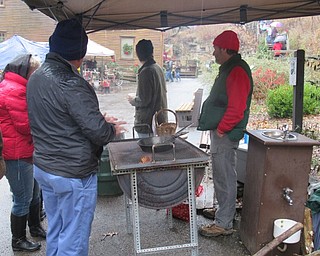 Neighbors | Jessica Harker.Mill Creek Park staff and volunteers roasted chestnuts for community members to try for free at the Olde Fashion Christmas event.