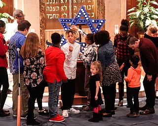 Students from Akiva Academy light the Star of David during their Hanukkah program at Congregation Rodef Sholom on Thursday evening. EMILY MATTHEWS | THE VINDICATOR