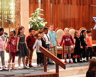 Kindergarteners from Akiva Academy sing and dance to The More We Get Together during their Hanukkah program at Congregation Rodef Sholom on Thursday evening. EMILY MATTHEWS | THE VINDICATOR